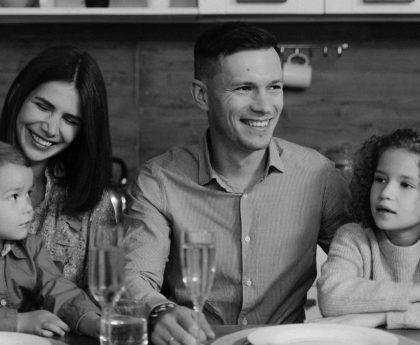 Smiling family enjoying quality time together at dining table in cozy kitchen.